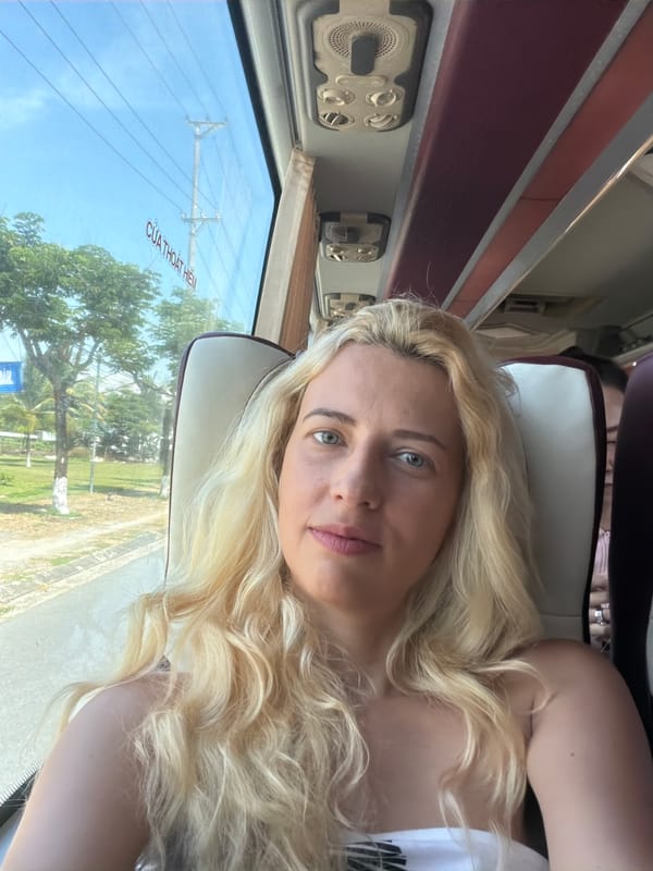 Blonde woman rests on bus seat in Đà Nẵng