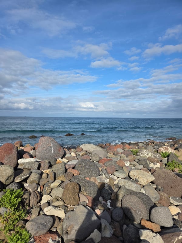 Rocky coastline captured under cloudy skies in Ensenada