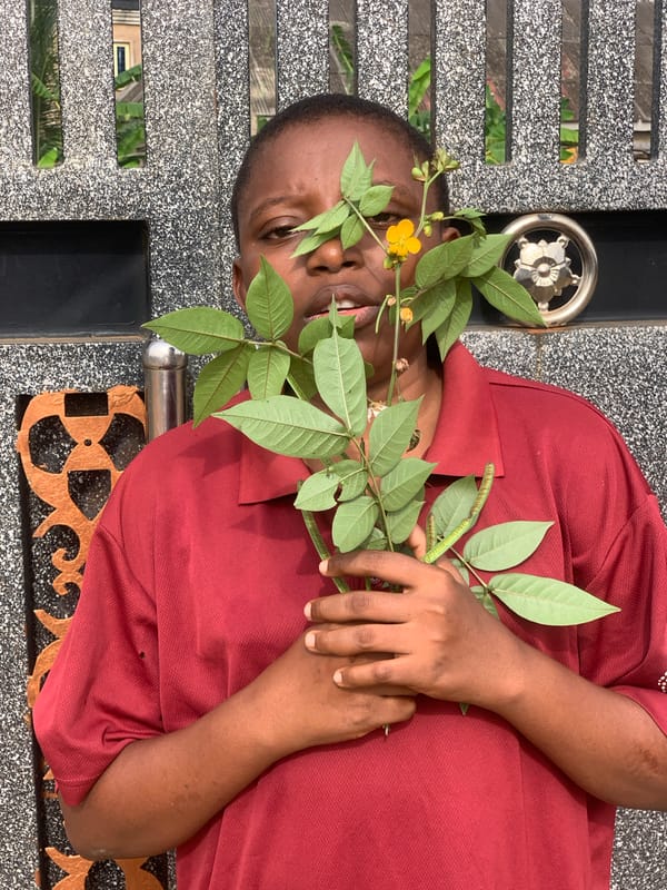 Person photographed in multiple poses with flowers in Ikorodu