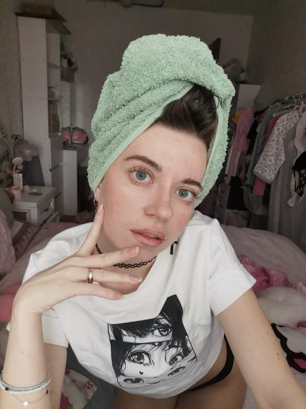 Woman's morning beauty routine captured in bedroom setting