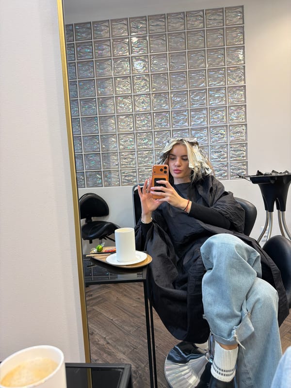 Woman takes salon selfies during hair coloring in Berlin