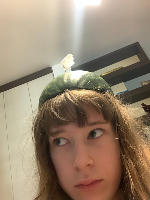 Person wears watermelon helmet with tissue flag in Belgrade