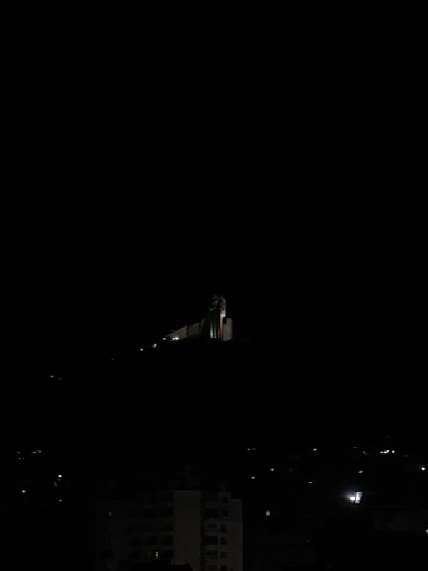 Witness documents nighttime urban residential area with illuminated buildings
