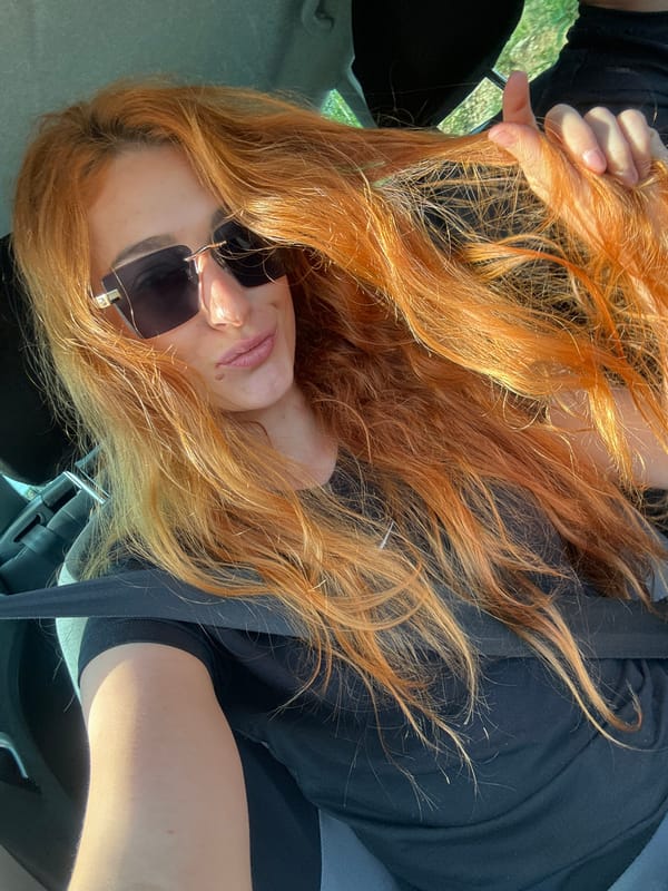 Red-haired passenger spotted making playful gestures in Montenegro car