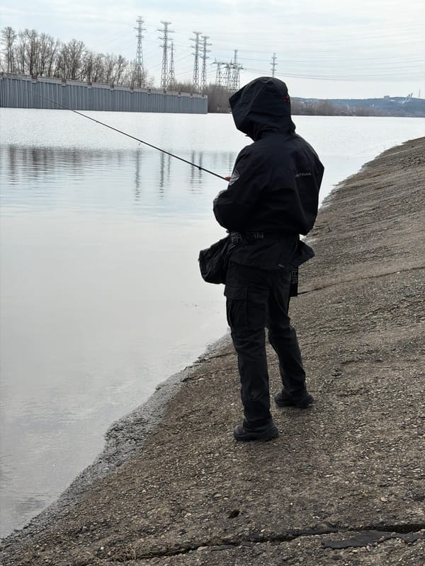 Angler fishes Kama River through ice in Chaikovsky, Russia