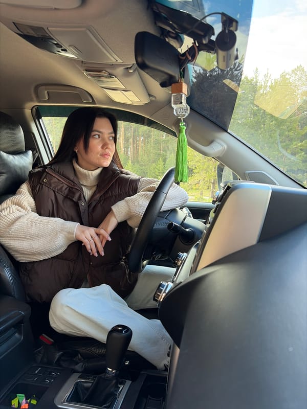 Woman observed in contemplative moment in car passenger seat