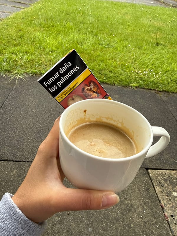 Coffee break moment captured over cigarette packet on pavement