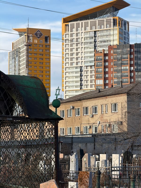 Morning scenes documented across Krasnoyarsk including cemetery, monument, construction