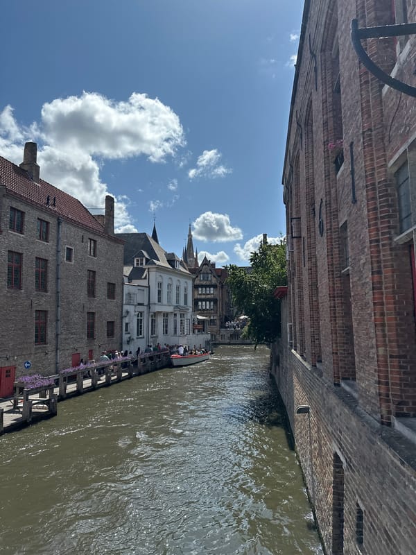 Bruges canals and cobblestone squares on a sunny afternoon