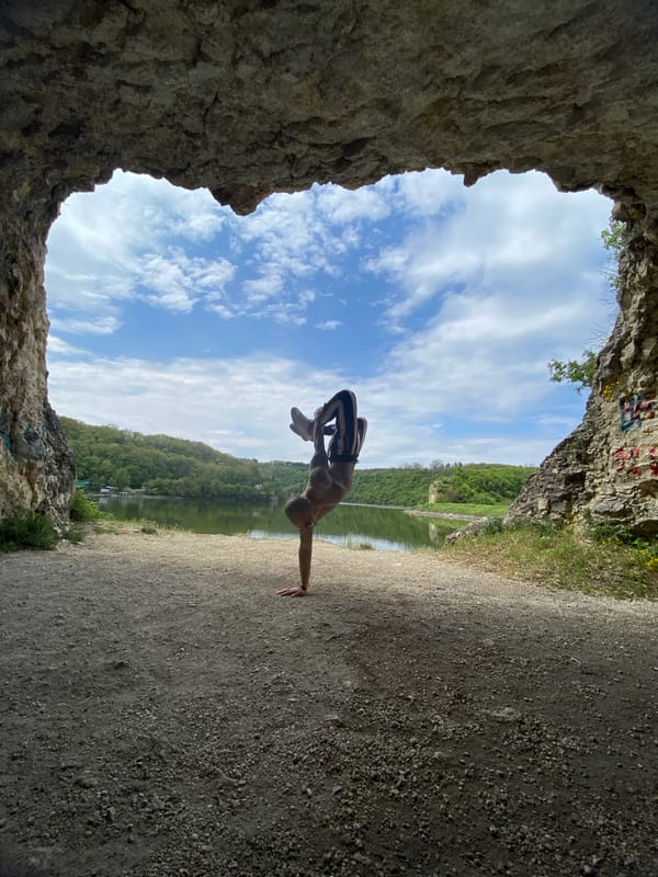Man performs yoga poses near lake in Pleven, Bulgaria