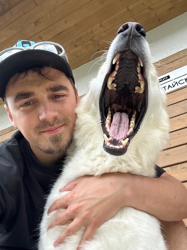 Man takes selfie with large white dog on Russian street