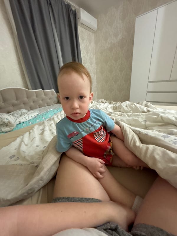 Mother and child share quiet morning moment in bed