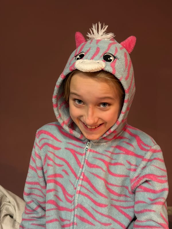 Child in unicorn onesie photographed in Dreiliņi, Latvia