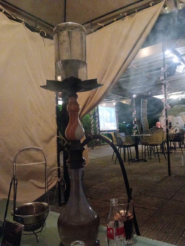Young men socialize at outdoor cafe in Burgas, Bulgaria