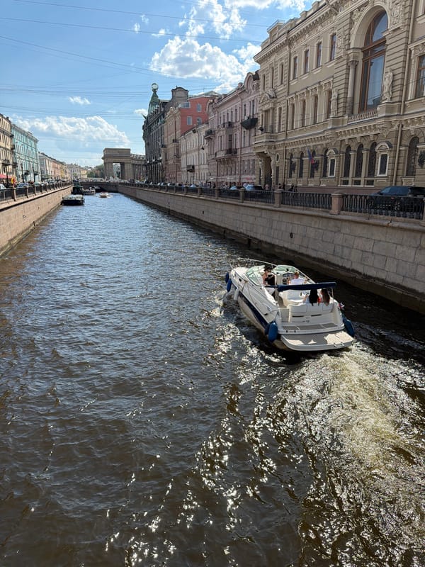 Tourist documents sunny canal cruise in Saint Petersburg
