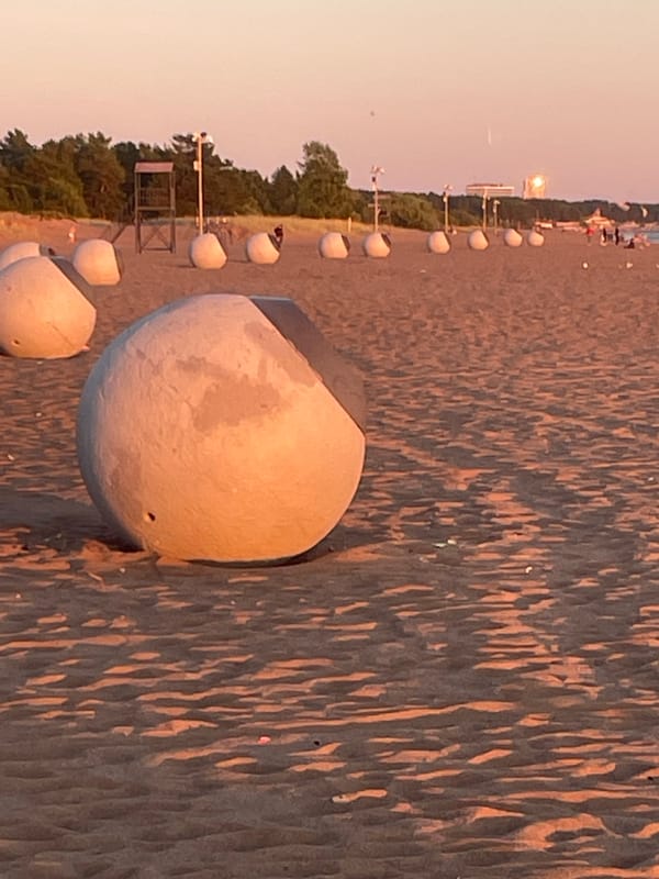 Sunset evening at Solnechnoye beach, swimmers and strollers out