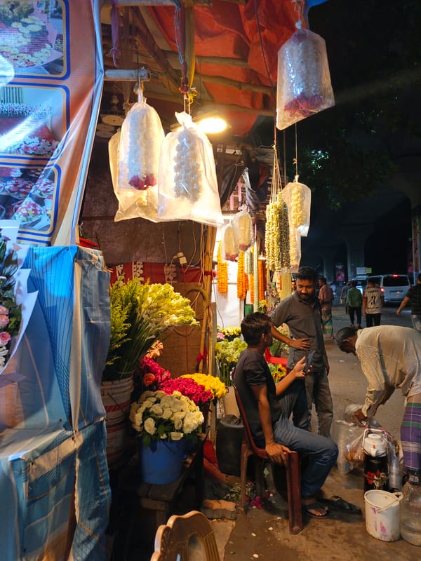 Evening flower market bustles along Dhaka street