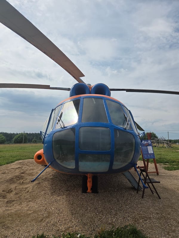 Mi-8 helicopter parked on gravel outside Bukharovo