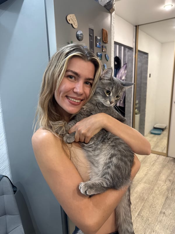 Woman photographed with pets in indoor selfies