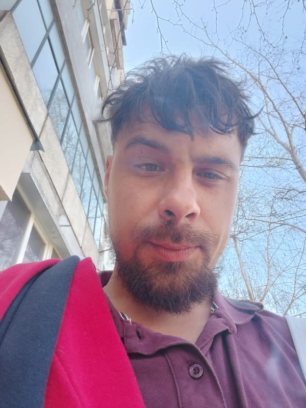 Man with eye bruise photographed in maroon polo shirt