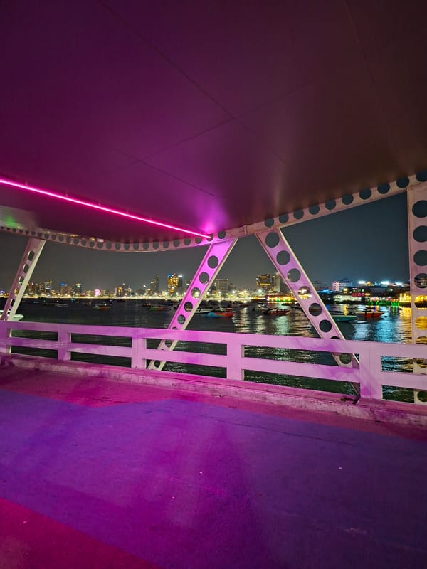 Pattaya waterfront glows in nighttime bridge crossing scenes