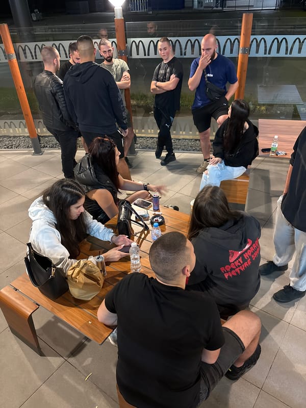 Adults gather on wooden bench in Sofia outdoor setting