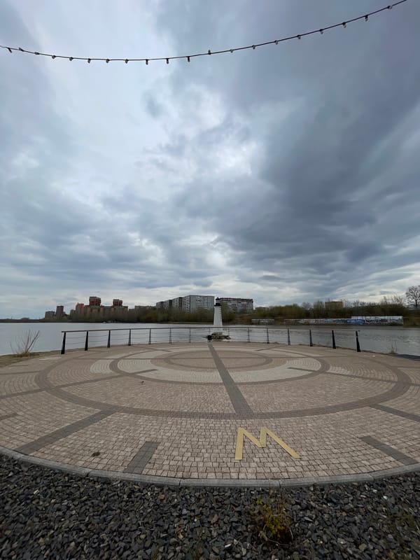 Yenisey River embankment with brass 'N' symbol documented in Krasnoyarsk