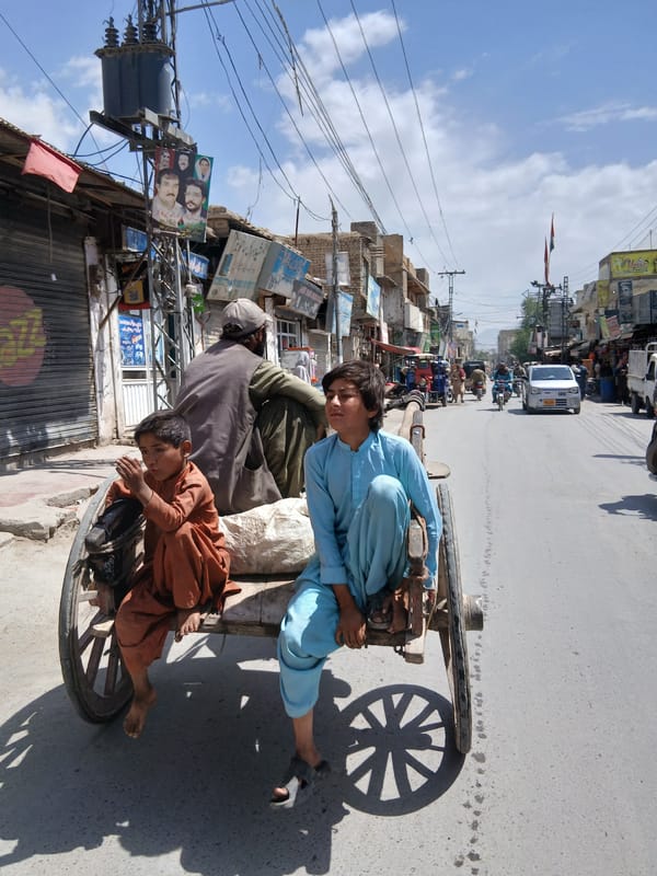 Street vendor sells produce from wheelbarrow in Quetta
