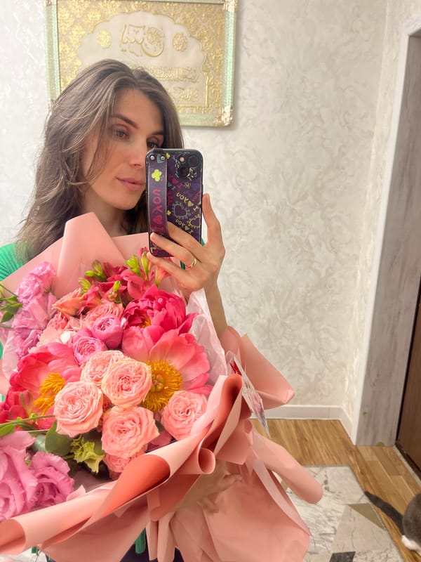 Woman celebrates with flower bouquets in Kaspiysk, Russia