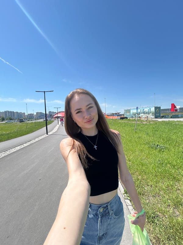 Woman takes selfies in sunny outdoor plaza area