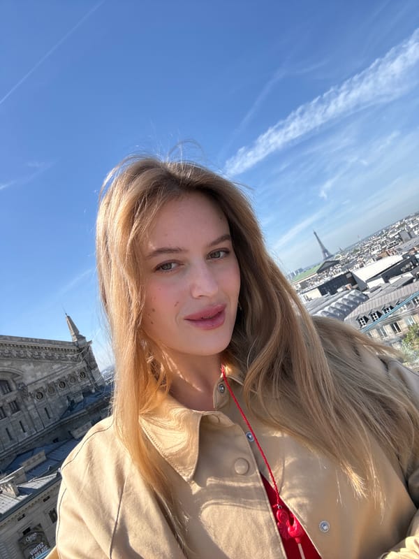 Woman takes selfies with Eiffel Tower backdrop in Paris