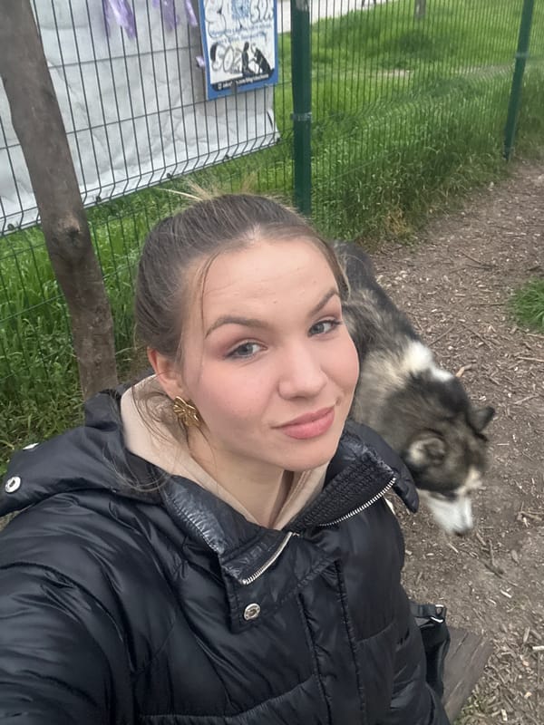 Young woman takes selfie with dog in Plovdiv park