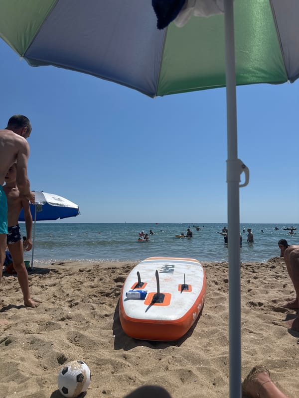 Paddleboard and beach gear on a sunny Sozopol shore