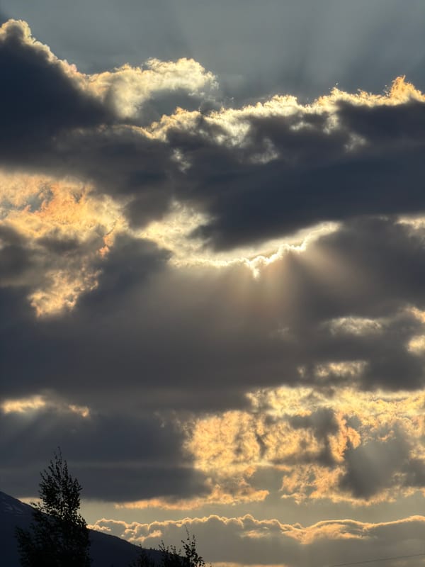 Dramatic sunbeams pierce clouds over Montenegro village