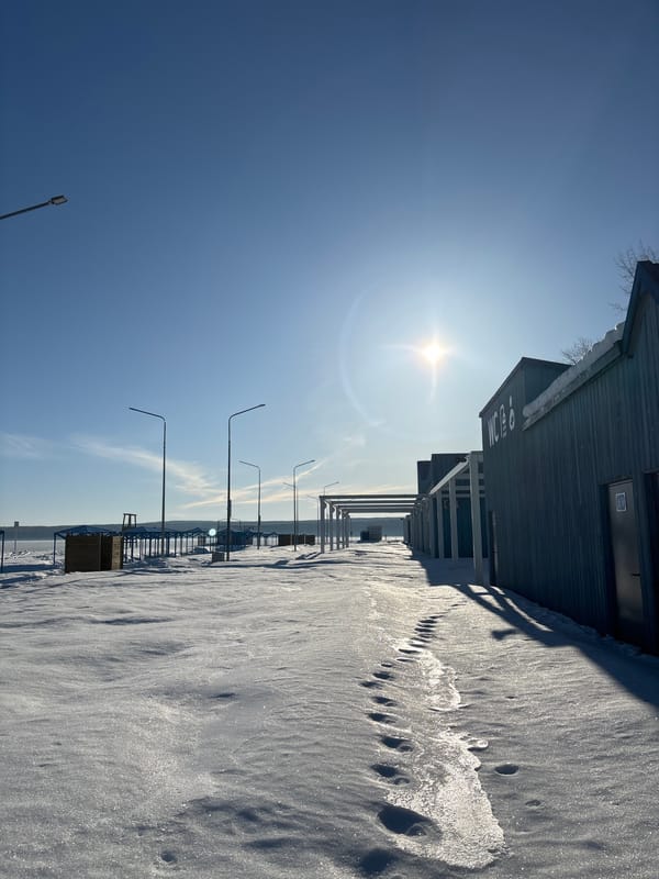 Snow-covered pier observed on sunny day in Chaikovsky, Russia