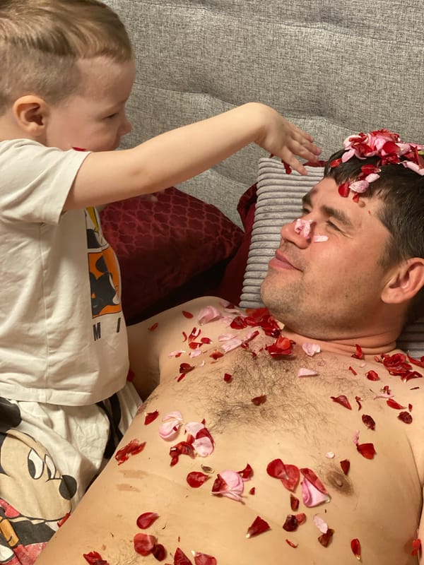 Child throws rose petals on resting man in Sochi home