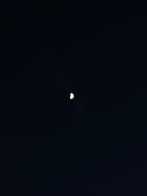 Crescent moon photographed in night sky over Шебунино, Russia