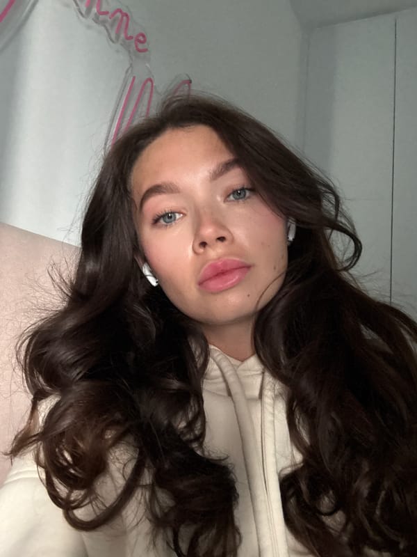 Woman takes selfies with pink device in Cyprus