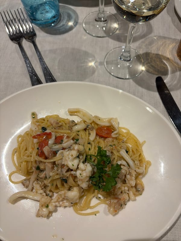 Diner enjoys seafood pasta at Milan restaurant