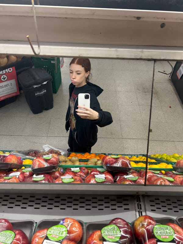 Woman takes mirror selfie in black hoodie, Buenos Aires