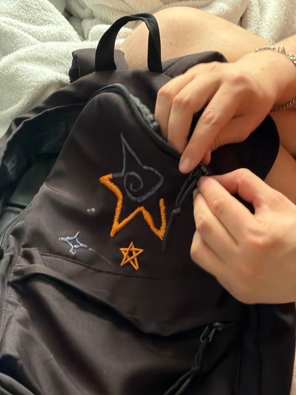 Person zips embroidered backpack in Perm, Russia