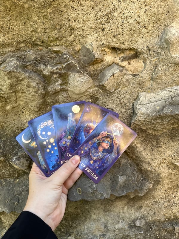 Tarot cards spread across ivy and stone in a Stuttgart garden