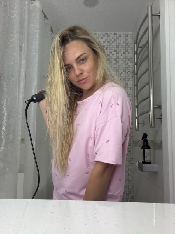 Woman documents hair routine with pets in Votkinsk bathroom