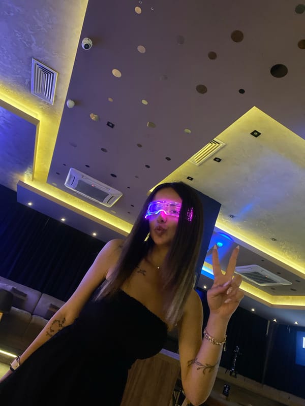 Woman in glowing glasses spotted in colorfully-lit Sofia room
