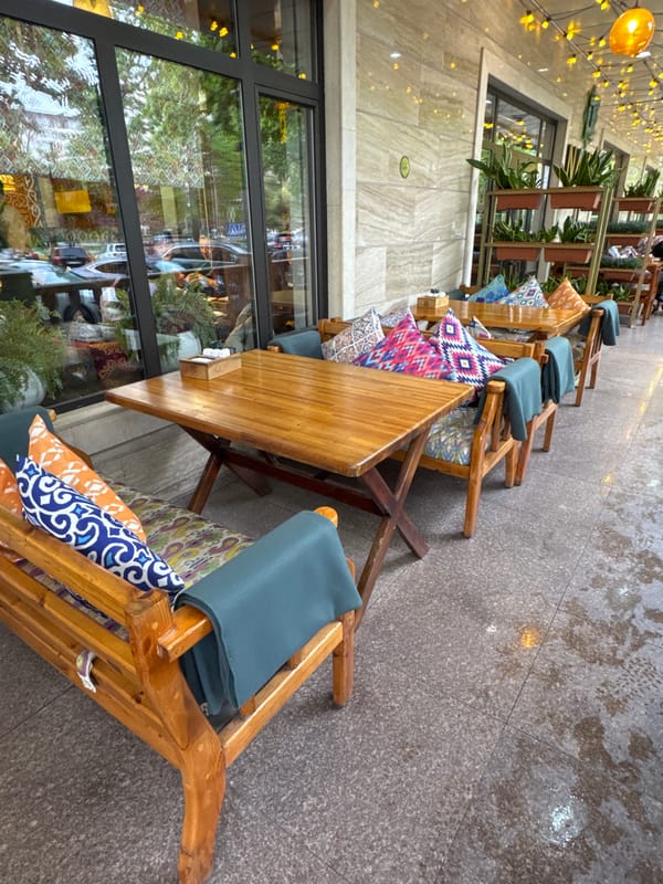 Morning cafe scene captured in post-rain Bishkek streets