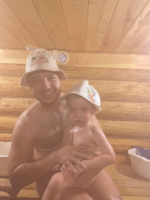 Father and child enjoy traditional sauna time in Russia