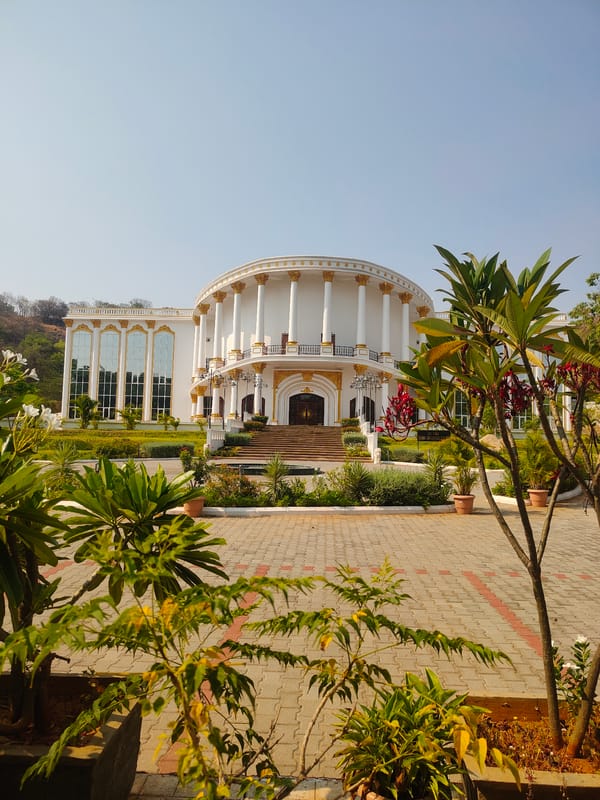 Classical white building with gold trim documented in Puttaparthi
