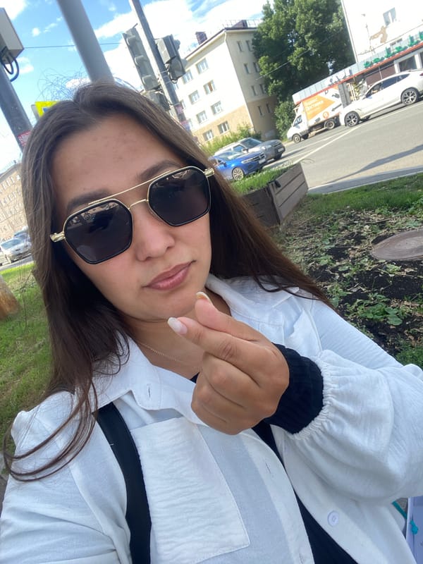 Waiting at a Ufa bus stop on a bright summer afternoon
