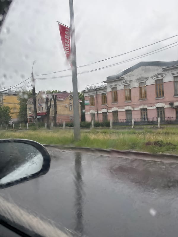 Woman in car during rainy morning in Rusanovo