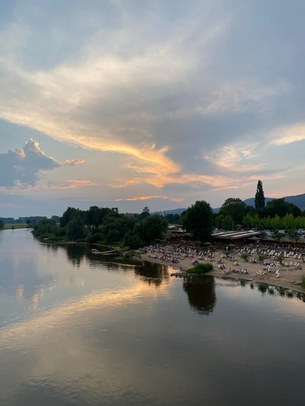 Busy summer evening along the Weser River at sunset